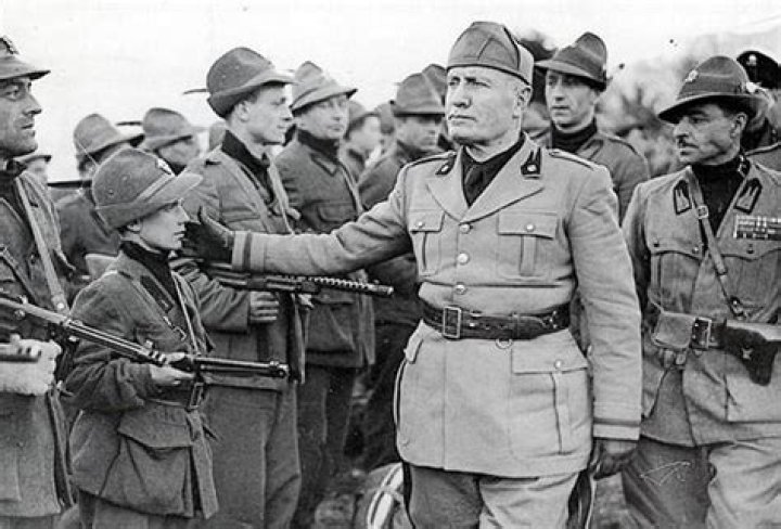 Benito Mussolini taps the cheek boy